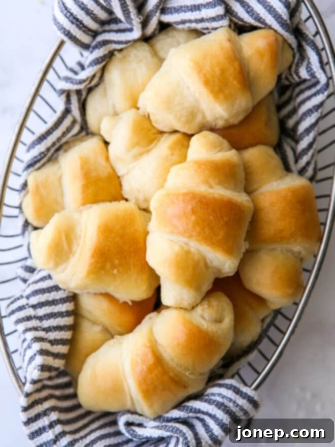 Effortless Cloud Crescents 9 closeup of easy no-knead fairy crescent rolls in a bread basket, showcasing texture