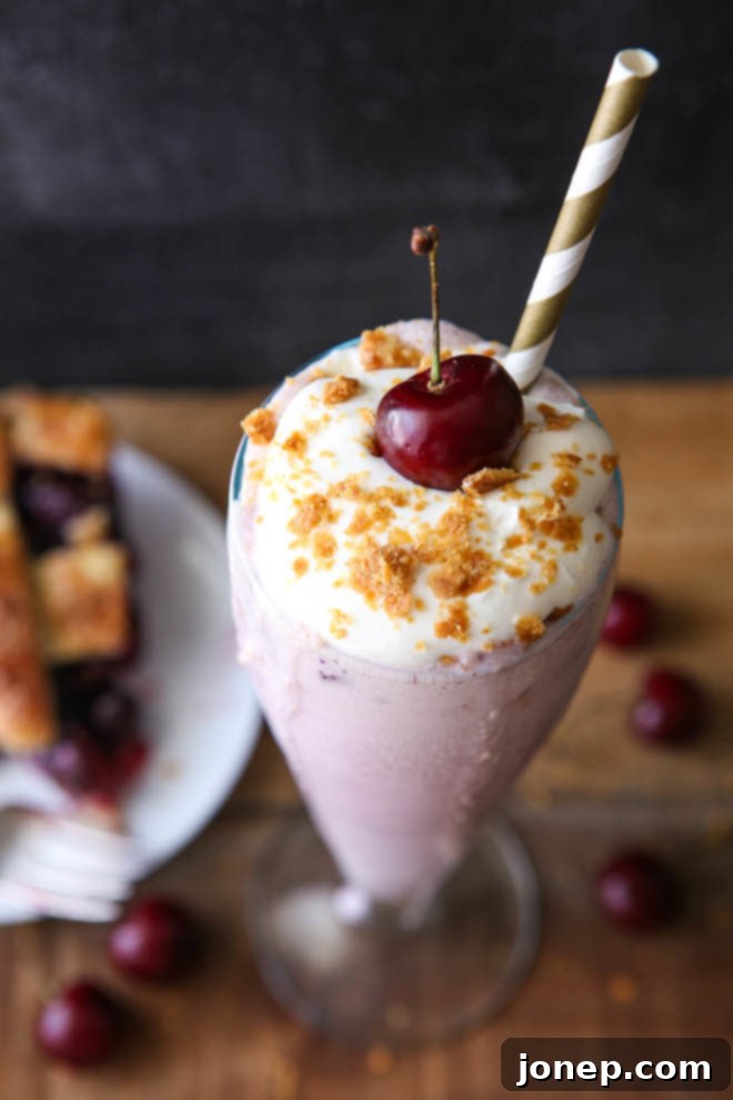 Close-up of a pie milkshake in a glass, topped with whipped cream, showing a smooth and creamy texture.