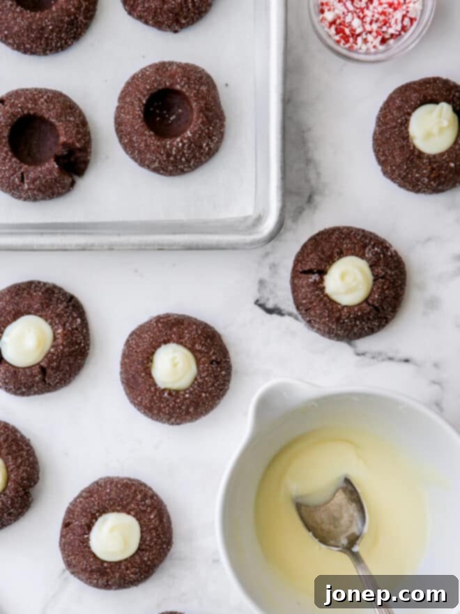 Cool Mint Chocolate Thumbprint Cookies 7 A tray of freshly baked chocolate mint thumbprint cookies with peppermint white chocolate ganache filling