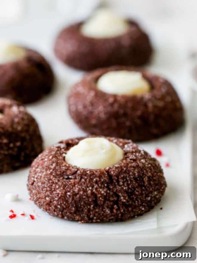 Cool Mint Chocolate Thumbprint Cookies 8 Close up view of several chocolate mint thumbprint cookies on a platter, showcasing the ganache