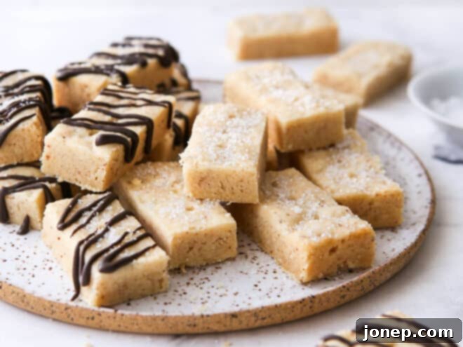 Nutty Brown Butter Shortbread 3 Closeup of a plate filled with golden-brown butter shortbread cookies, showing their crumbly texture and delicious details.