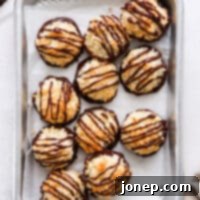 coconut macaroons drizzled with chocolate on a sheet pan