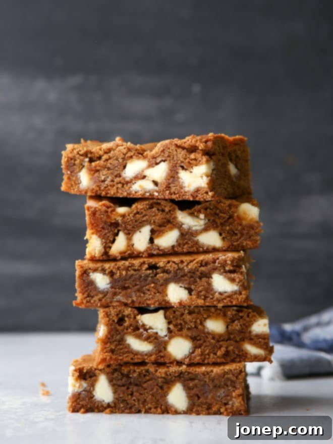 Soft, chewy Molasses White Chocolate Blondies with warm spices, cut into perfect squares.