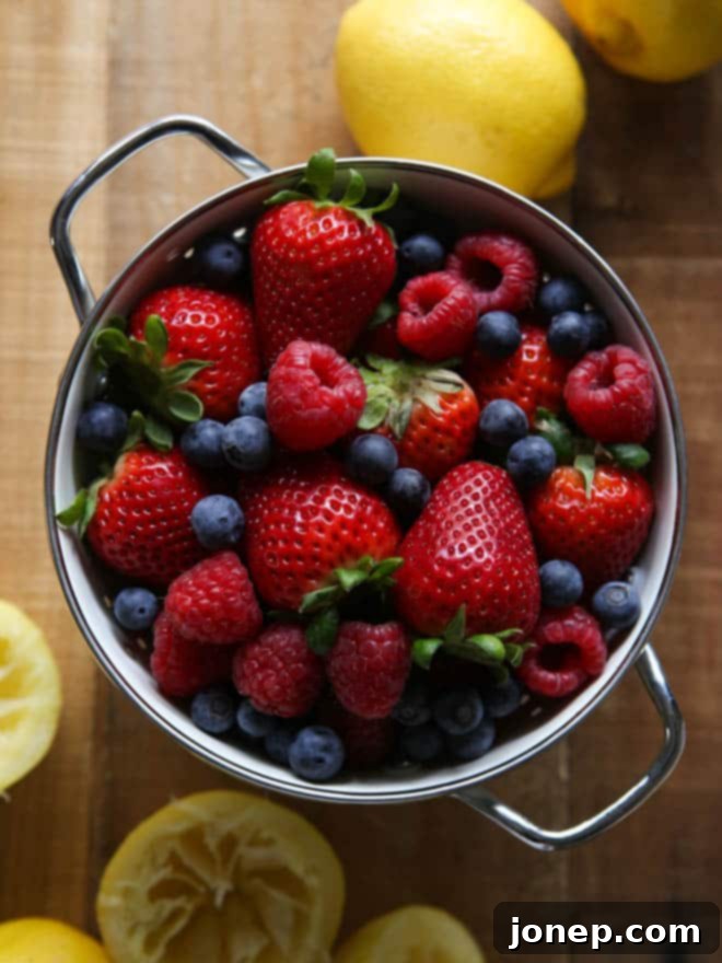 Arrangement of unbaked Lemon Berry Shortcake biscuits, with fresh berries and lemons in the background, hinting at fresh ingredients.