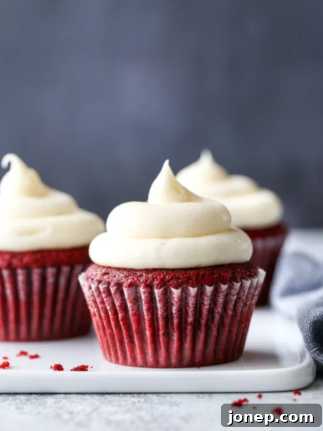 Classic red velvet cupcakes, tender and moist, with luscious cream cheese frosting, ready to be enjoyed.