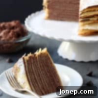 Decadent Whipped Chocolate Ganache Crepe Cake 2 A slice of Crepe Cake with Whipped Chocolate Ganache, dusted with powdered sugar.