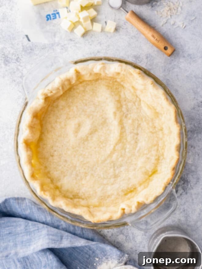 Master Blind Baking for Flawless Pie Crusts 2 A perfectly blind baked pie crust sitting on a linen cloth, golden brown and perfectly shaped.