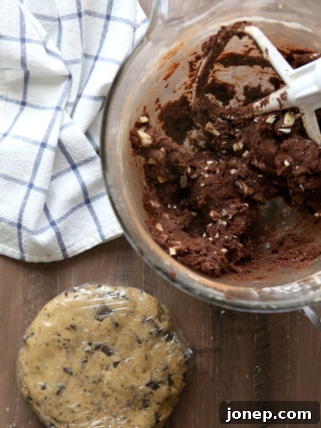 Unbaked cookie dough balls showing the intricate swirl pattern of malted dark chocolate and reverse chip doughs.