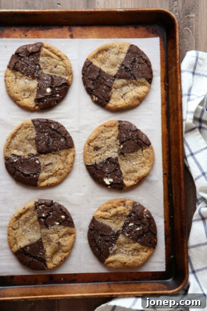 Stack of four delicious Swirled Malted Chocolate Chip and Reverse Chip Cookies on a plate, ready to be enjoyed.