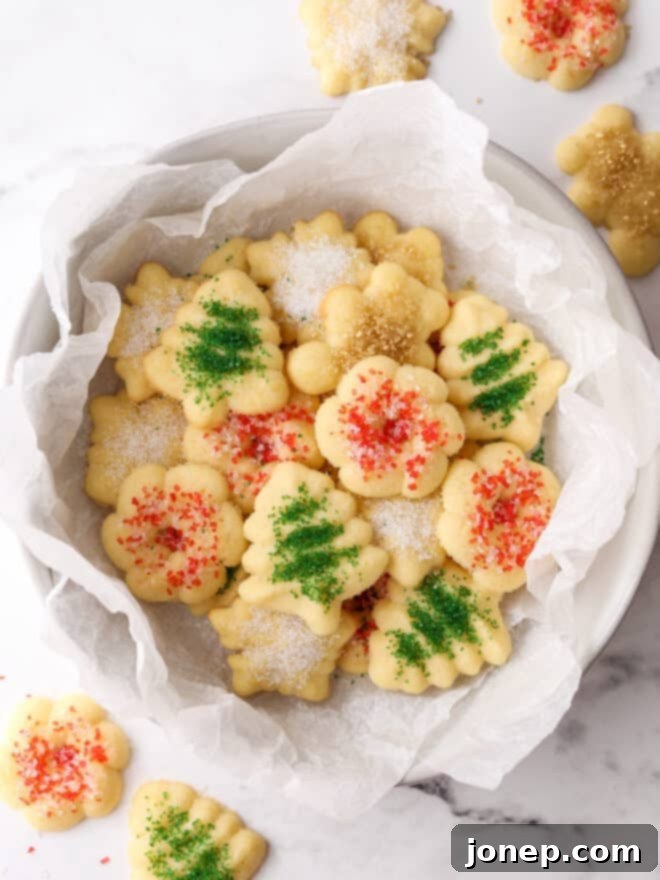 Festive Spritz Cookie Delights 2 A bowl filled with beautifully decorated spritz cookies, showcasing various festive shapes and sprinkles, ready for holiday enjoyment.