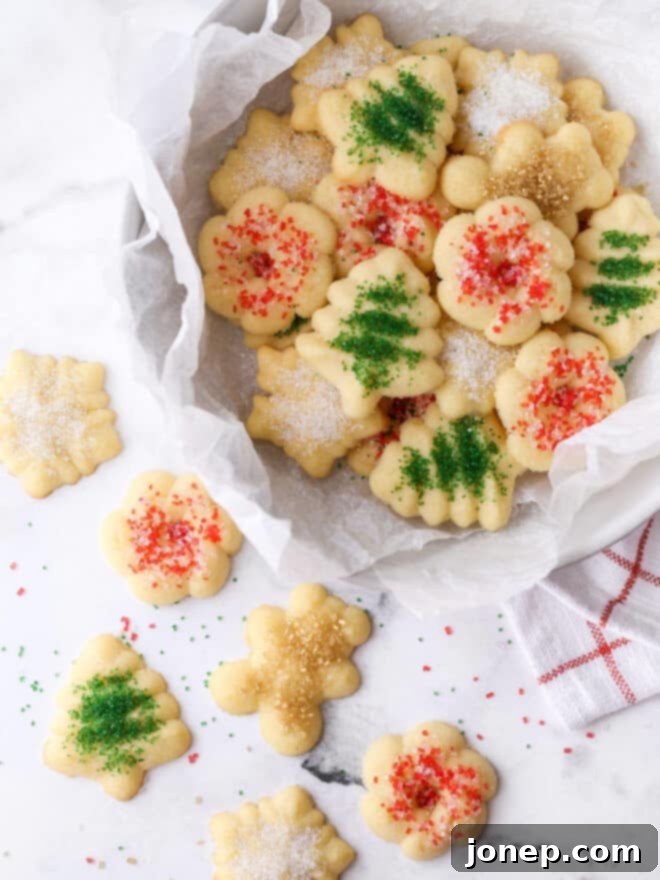 Festive Spritz Cookie Delights 9 A beautiful display of baked spritz cookies, some in a rustic bowl and others artfully arranged on a wooden table, invitingly decorated with sprinkles.