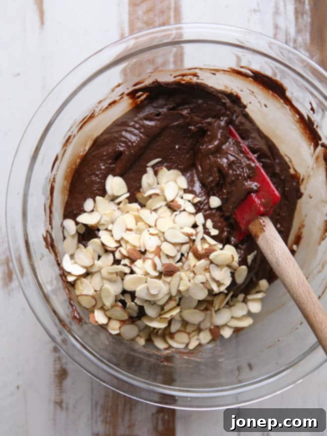 Fudge layers being assembled: chocolate base, then white coconut layer