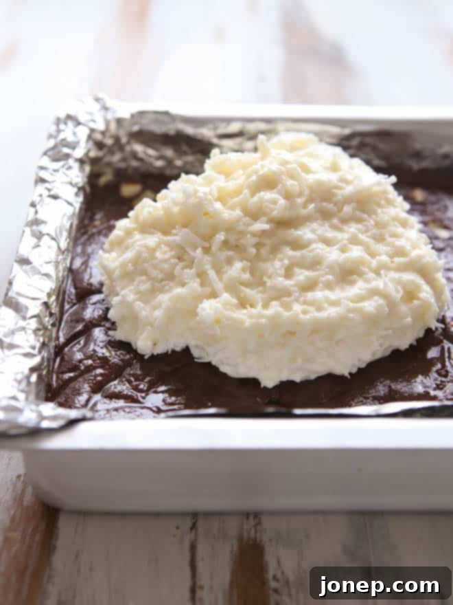 Smooth coconut layer spread over the chocolate fudge base