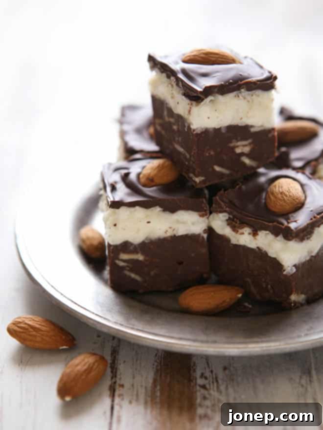 Serving slices of Coconut Almond Fudge on a platter