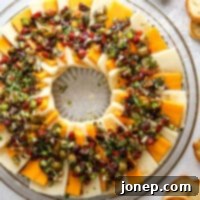 Zesty Marinated Cheese 7 Marinated Cheese Appetizer platter with herbs and olives