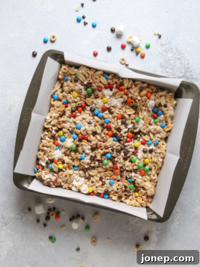 Preparing the mixture for Monster Marshmallow Cereal Treats in a large bowl