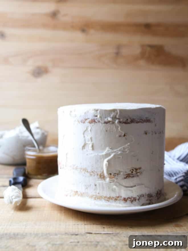 A close-up of the elegant Bourbon Butterscotch Cake, showcasing the textured frosting and a generous drizzle.