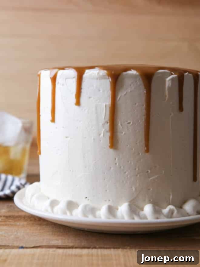 A perfectly sliced piece of Bourbon Butterscotch Cake on a plate, showcasing its beautiful layers.