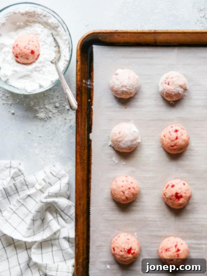 baked cherry almond snowballs dipped in powdered sugar