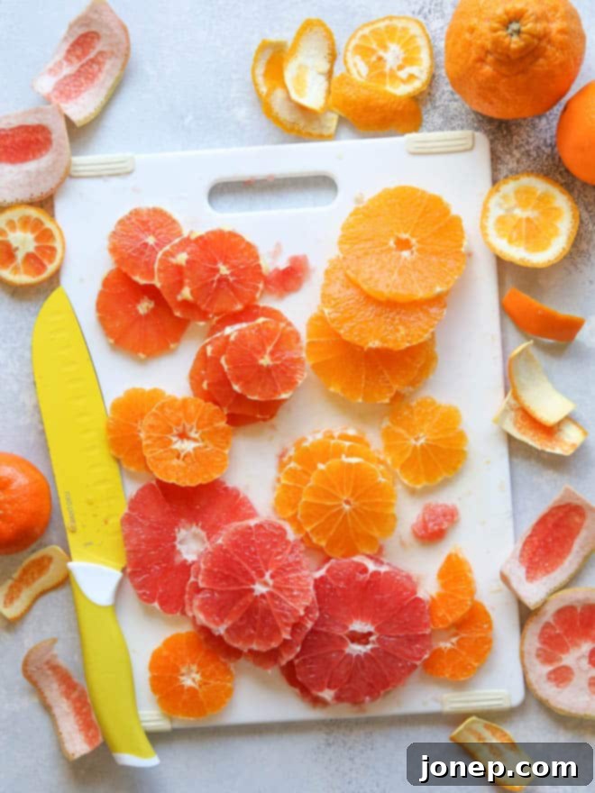 Bright Citrus Yogurt Pizza with Crunchy Granola Crust 5 Hands arranging colorful citrus on a yogurt fruit pizza