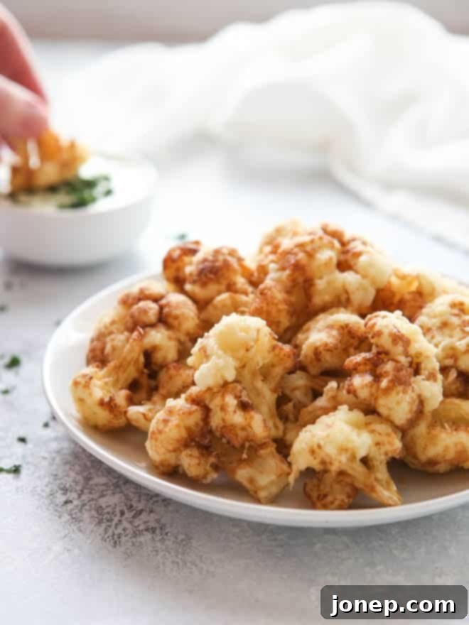 Light and Crispy Cauliflower Tempura 6 Stack of crispy tempura cauliflower on a plate, ready to be enjoyed