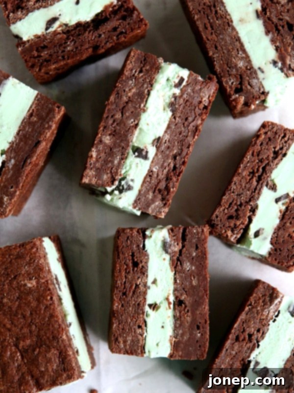 Minty Cocoa Bliss Cupcakes 10 Decadent Mint Chocolate Chip Ice Cream Brownie Bars, featuring distinct layers of fudgy chocolate brownie, cool mint ice cream, and a rich chocolate topping, perfect for a chilled treat.