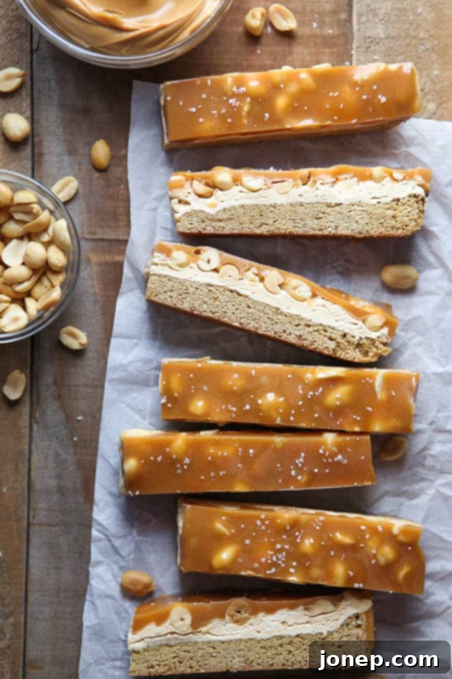 Delicious Salted Caramel Peanut Bars stacked on a plate, showcasing the multiple layers of blondie, peanut butter, and caramel.