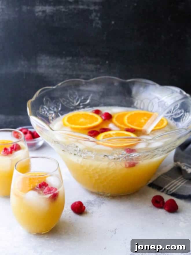Mimosa Punch served in glasses with orange slices