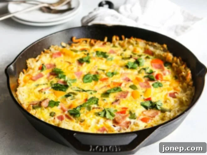 A close-up of the hash brown crust of the frittata in a cast iron skillet