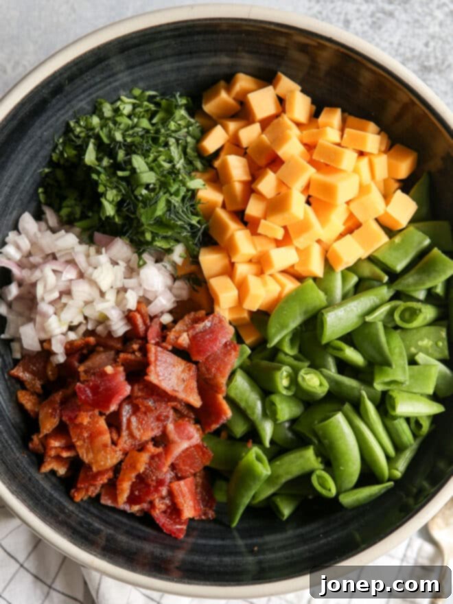 Luscious Creamy Sugar Snap Pea and Bacon Salad 4 all of the components in a bowl for sugar snap pea salad