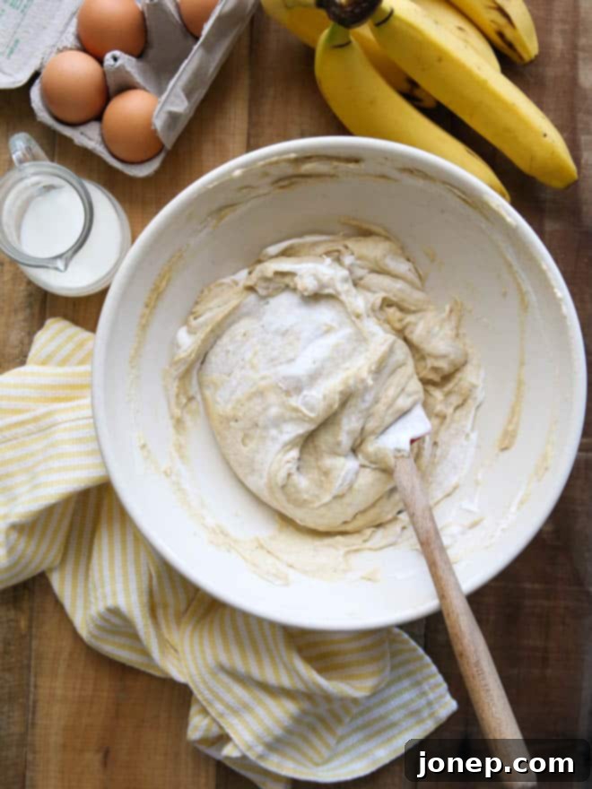 Close-up of the smooth, creamy filling and layered bananas in a Bourbon Banana Cream Pie, ready to be topped with whipped cream.