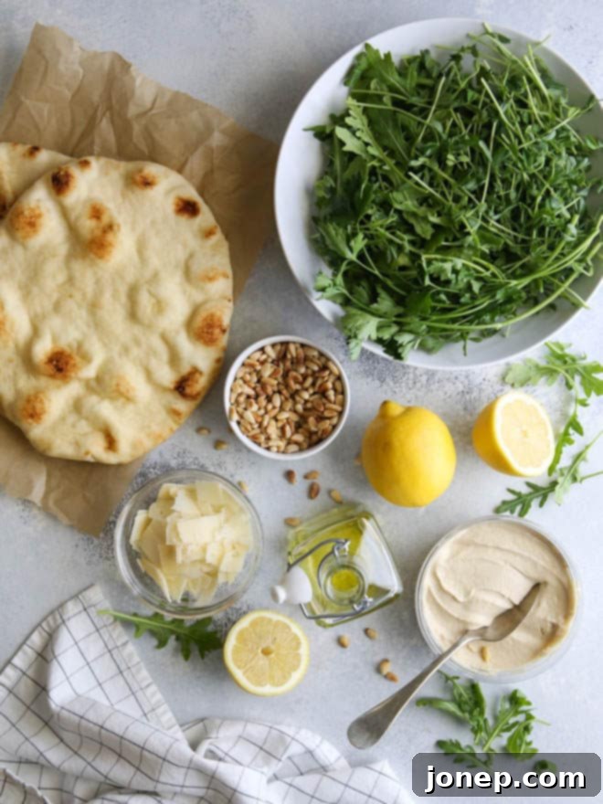 Fresh Hummus and Salad Flatbread Pizza with pine nuts and Parmesan