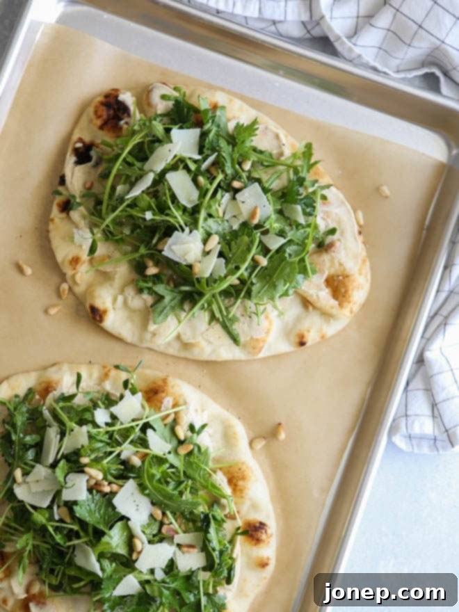 Serving Hummus and Salad Flatbread Pizza cut into wedges