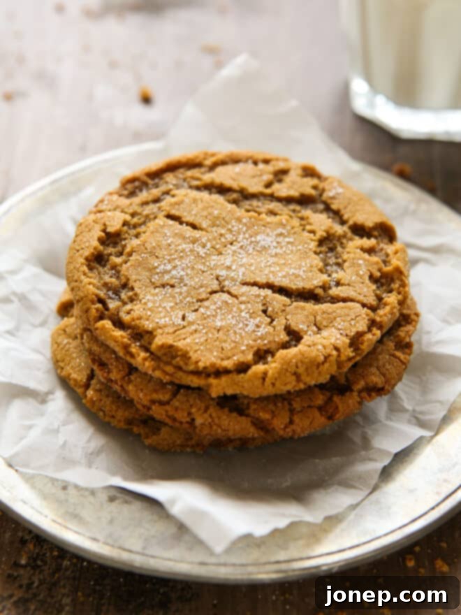 Soft-Baked Ginger Spice Cookies 3 stack of gingersnaps on a plate with glass of milk