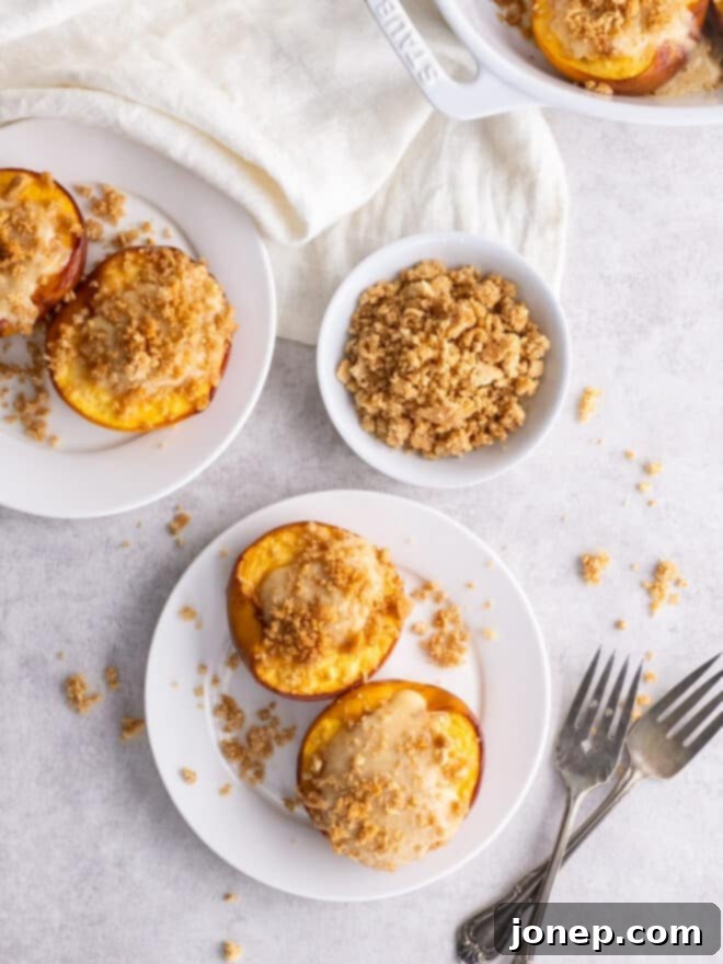 Cheesecake Stuffed Peaches with Graham Cracker Crumble 3 cheesecake stuffed peaches on serving plates