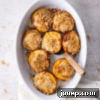 Cheesecake Stuffed Peaches with Graham Cracker Crumble 9 baking dish with baked cheesecake stuffed peaches