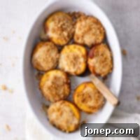 Peaches & Cream Cheesecake Crumble 9 baking dish with baked cheesecake stuffed peaches