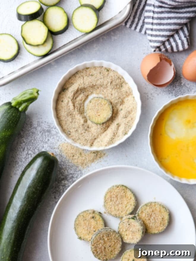Dredging zucchini in breadcrumbs