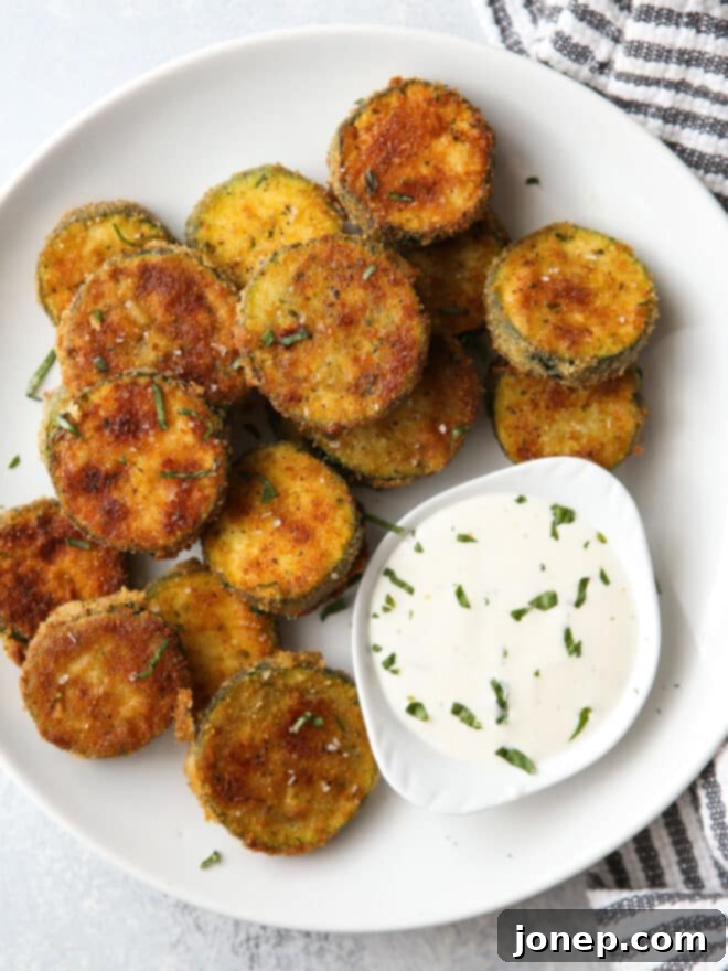 Crispy zucchini on a plate with ranch dressing