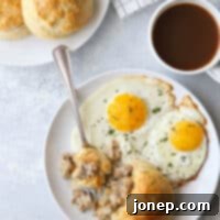 Buttermilk biscuits with sausage gravy on the inside, showing a perfectly baked cross-section