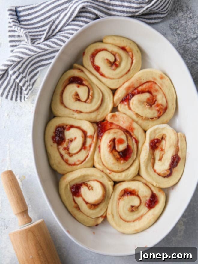 Peanut Butter and Jam Sweet Rolls arranged in a baking dish, ready for the oven to bake.