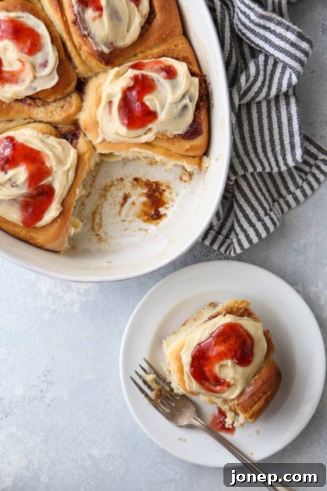 A close-up of a Peanut Butter and Jam Sweet Roll, showing the delicious swirled filling and frosting.