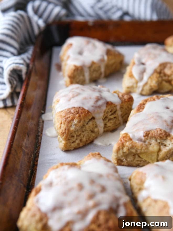 Stack of finished apple cinnamon scones, glazed and ready to eat
