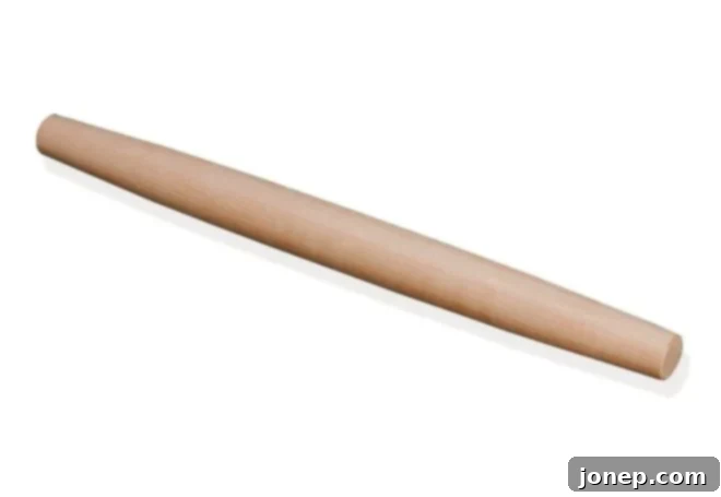 A sleek French-style rolling pin, ideal for evenly rolling out pie dough.
