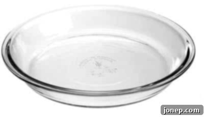A classic clear glass pie dish, showing its standard 9-inch diameter and flat edge.