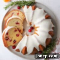 Zesty Cranberry Orange Bundt 10 Cranberry Orange Bundt Cake and slices on a plate, ready to be served.