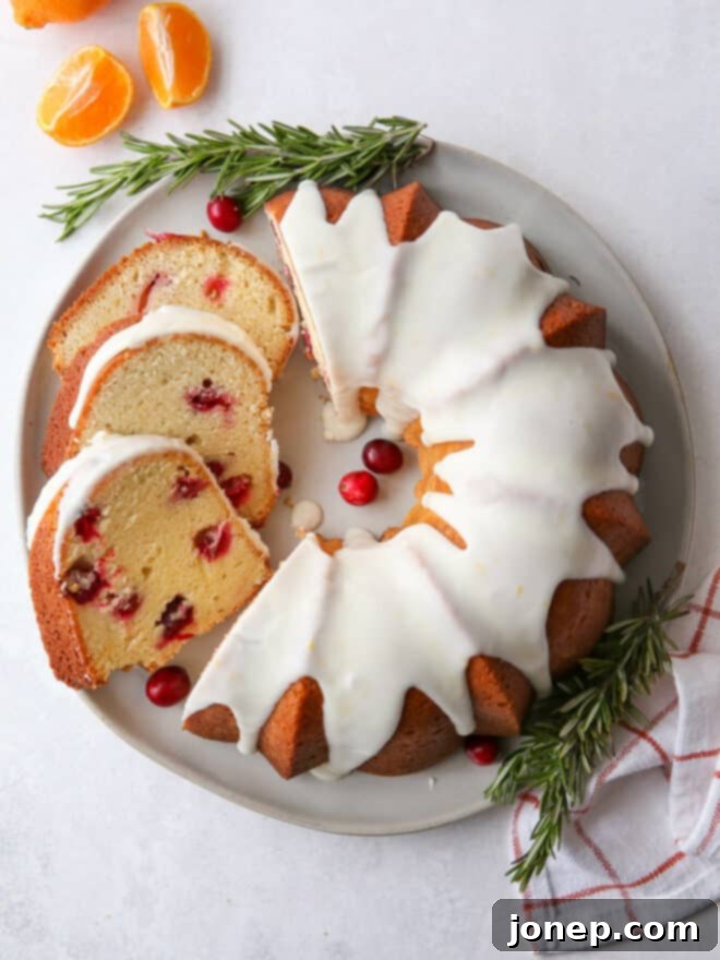 Zesty Cranberry Orange Bundt 3 Whole Cranberry Orange Bundt Cake alongside several perfectly sliced portions on a plate.