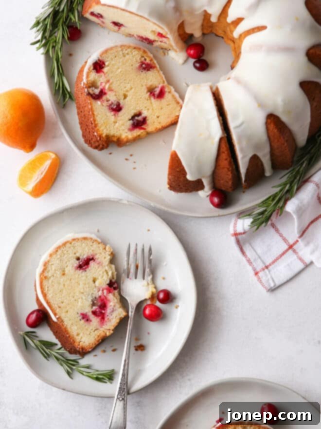 Zesty Cranberry Orange Bundt 9 A slice of Cranberry Orange Bundt Cake with a bite taken out, showing its light and airy texture.