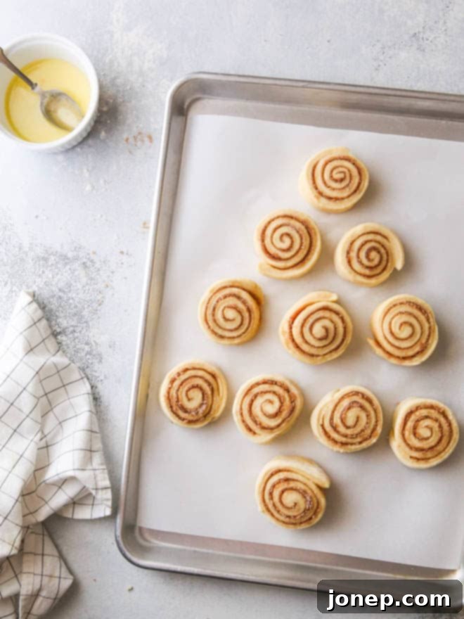 A delicious cinnamon roll Christmas tree, beautifully frosted and ready to be served for holiday breakfast.