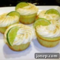Zesty Key Lime Cupcakes 2 Close-up of a Key Lime Cupcake with green frosting and lime zest